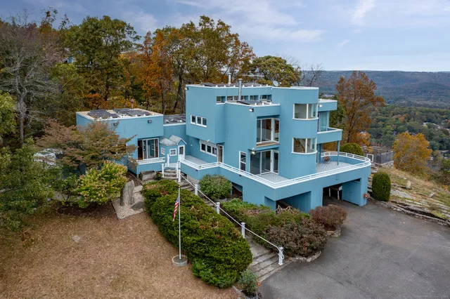 an aerial view of a house with a yard and potted plants