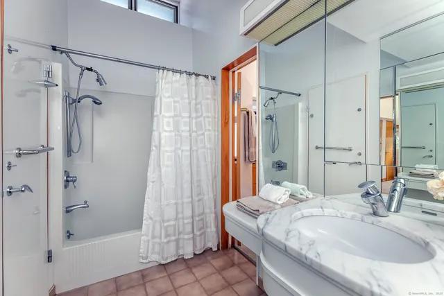 a living room with a bed and a table