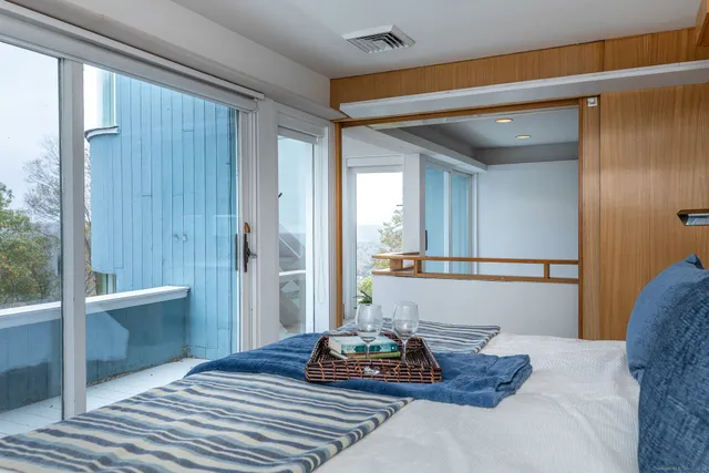 a spacious bedroom with a bed and a window