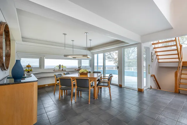 a living room with furniture and large windows