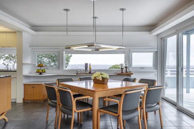 a dining room with furniture a chandelier and a rug