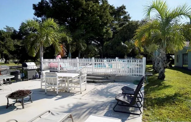 a view of a tennis court with wooden fence