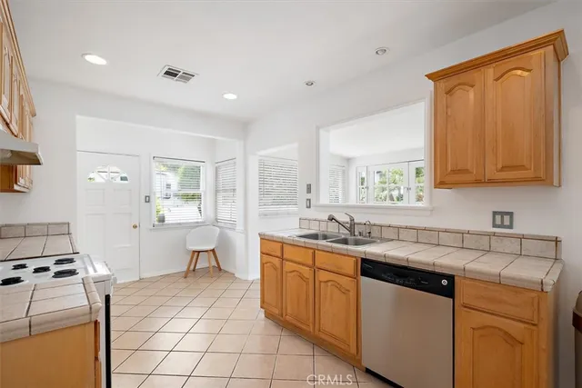 a kitchen with a sink stove and cabinets