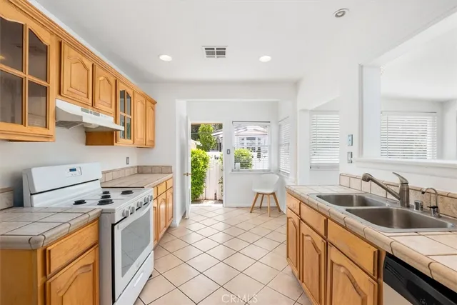 a kitchen with a sink stove and cabinets