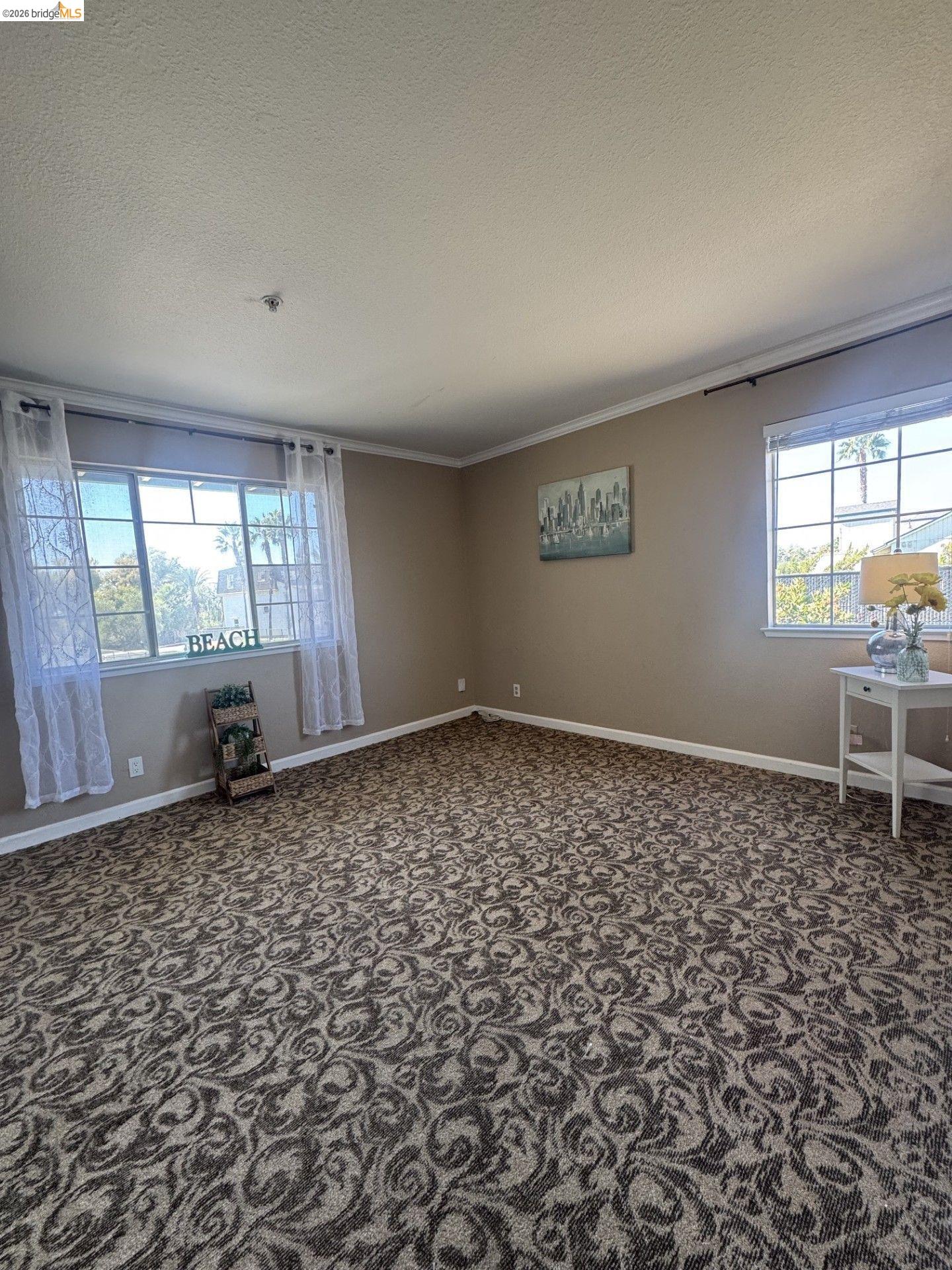 3623 Wells Road Oakley, CA 94561 - Photo 34 of 75 Spacious bedroom featuring upgraded patterned carpeting, multiple windows for natural light, and crown molding