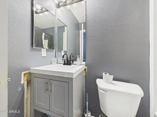a bathroom with a sink and a refrigerator