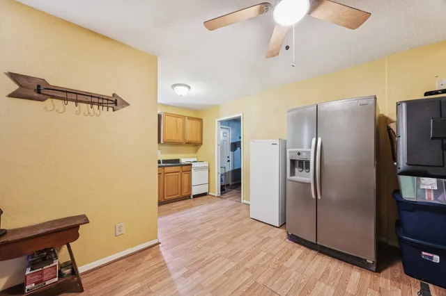 a kitchen with stainless steel appliances a refrigerator and a stove top oven