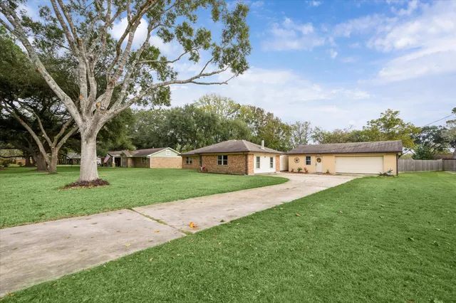 a front view of a house with yard and green space