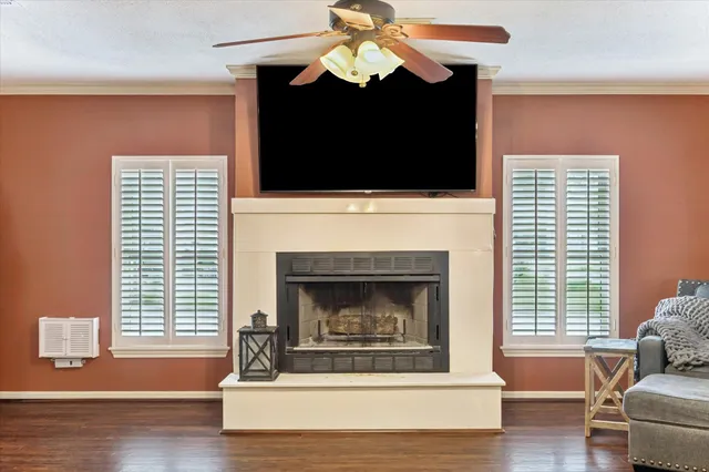 a living room with a fireplace and a flat screen tv