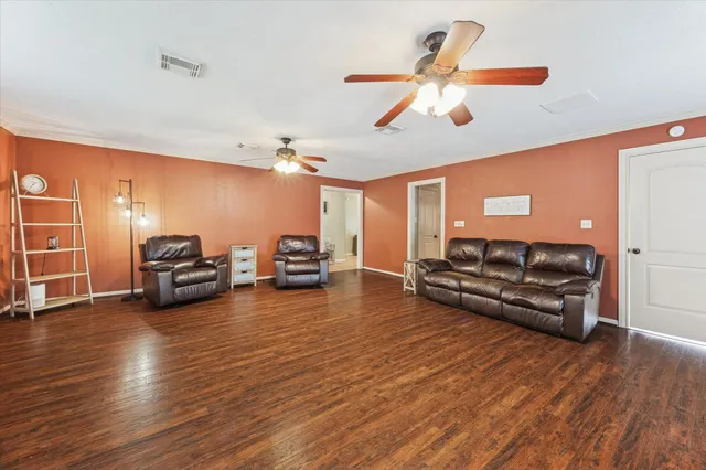 a living room with furniture and wooden floor