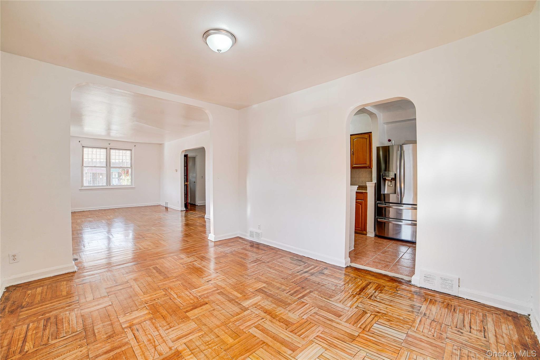 993 Duncan Street Bronx, NY 10469 - Photo 11 of 32 wooden floor in an empty room with a window