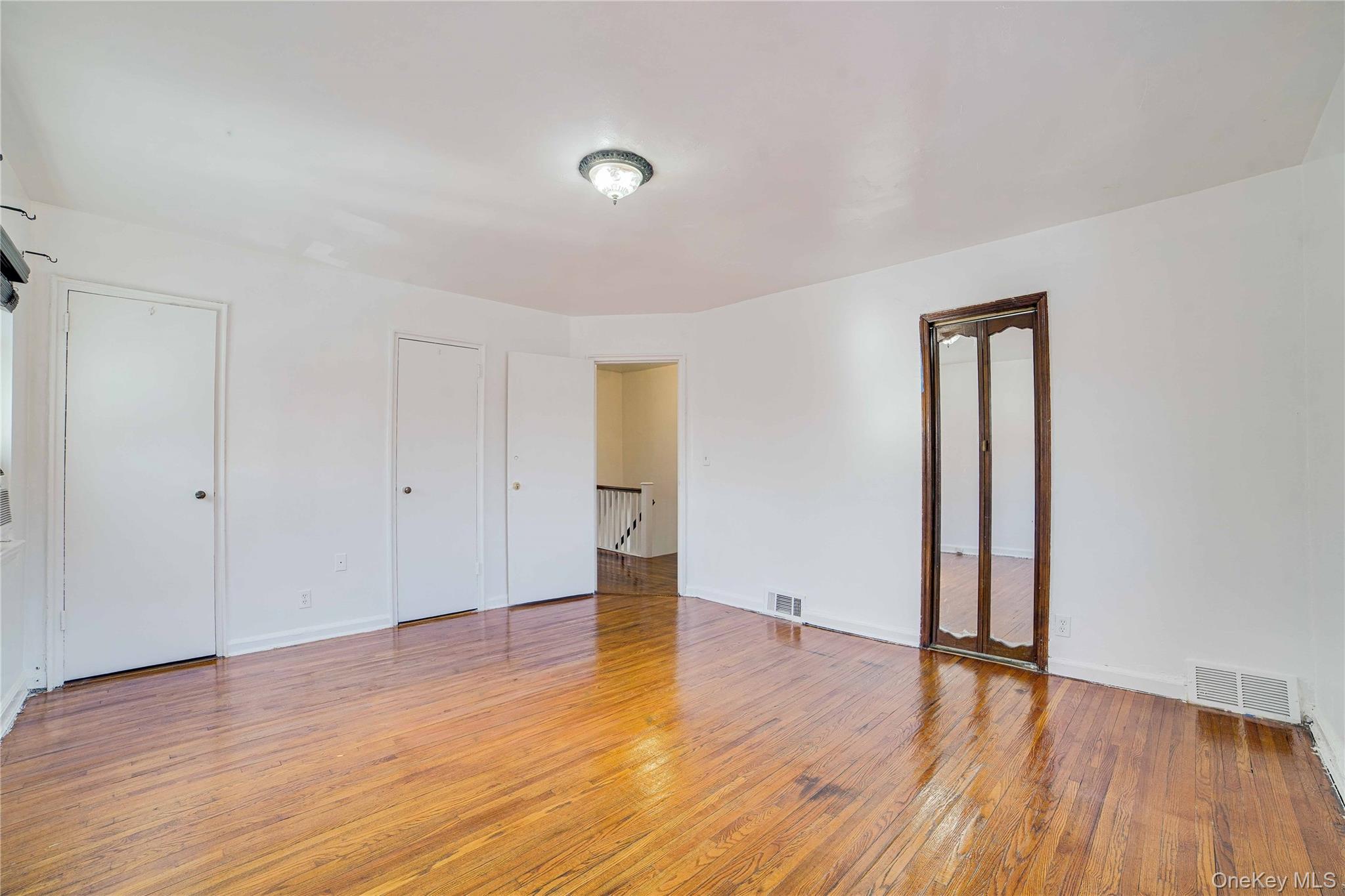 993 Duncan Street Bronx, NY 10469 - Photo 13 of 32 a view of an empty room with wooden floor and a window