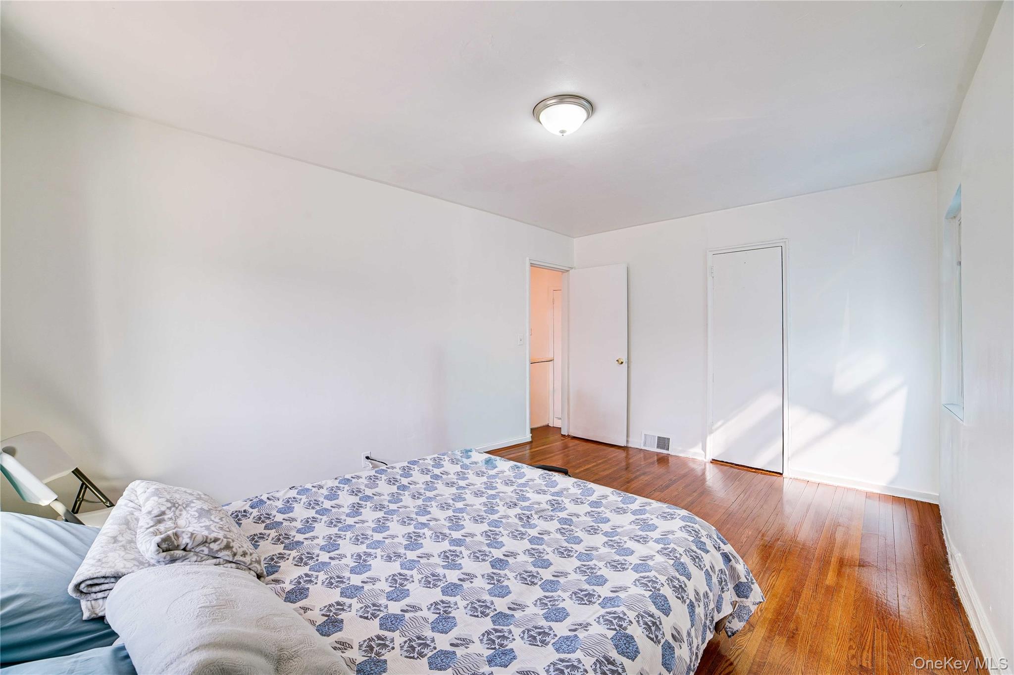 993 Duncan Street Bronx, NY 10469 - Photo 19 of 32 a bedroom with a bed and a window