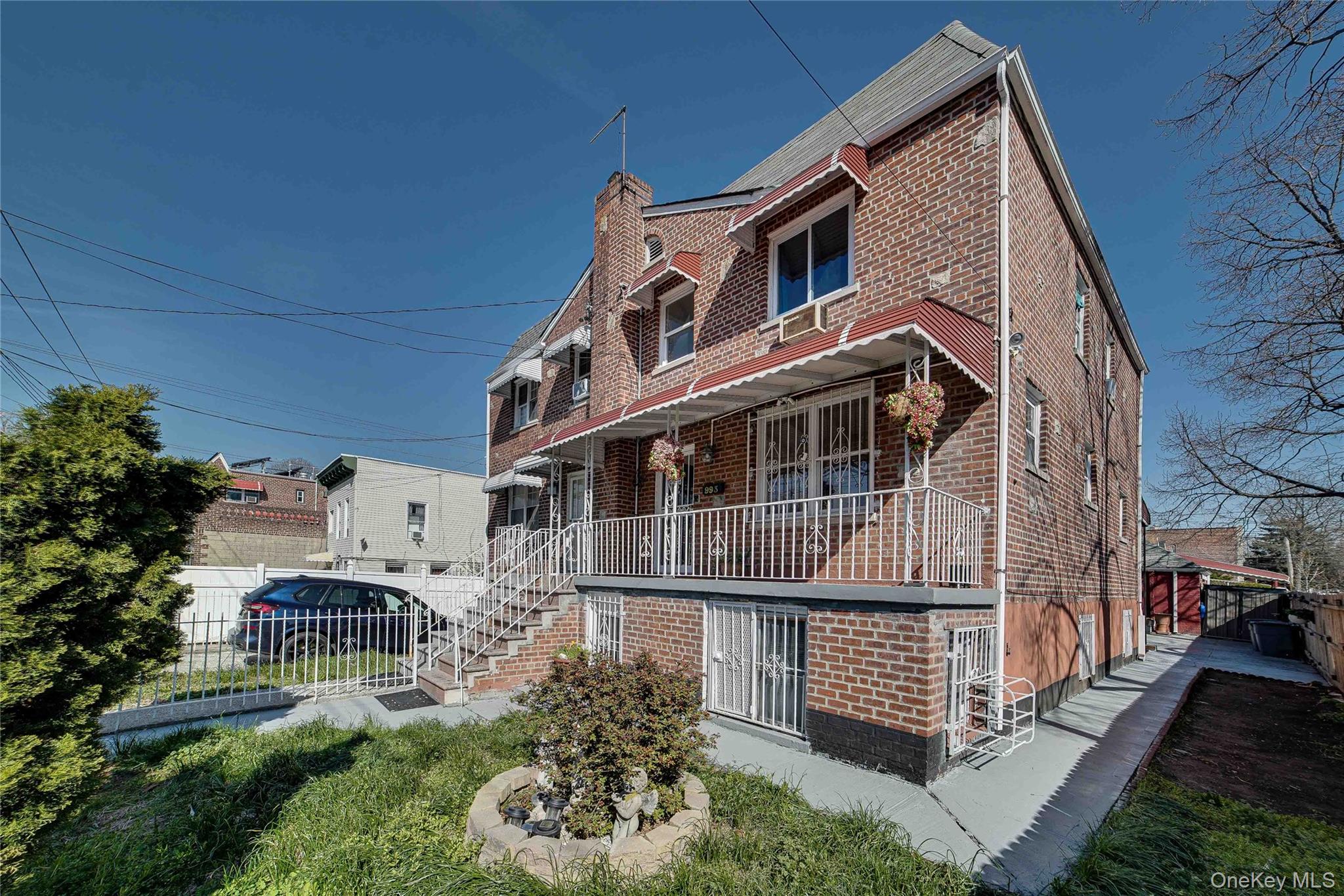 993 Duncan Street Bronx, NY 10469 - Photo 24 of 32 a front view of a house with a yard