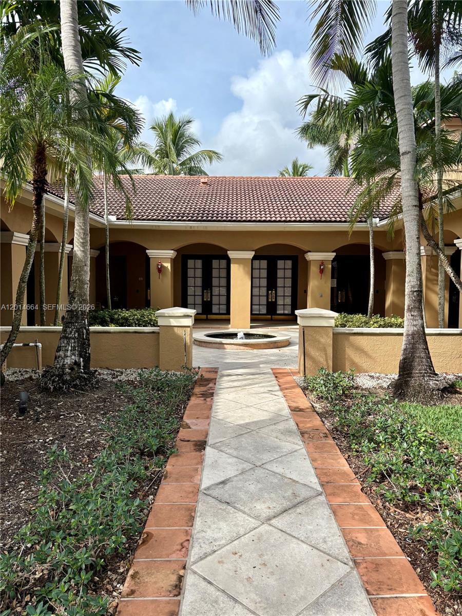 8030 North Nob Hill Road, Unit 105 Tamarac, FL 33321 - Photo 19 of 22 a front view of a house with garden