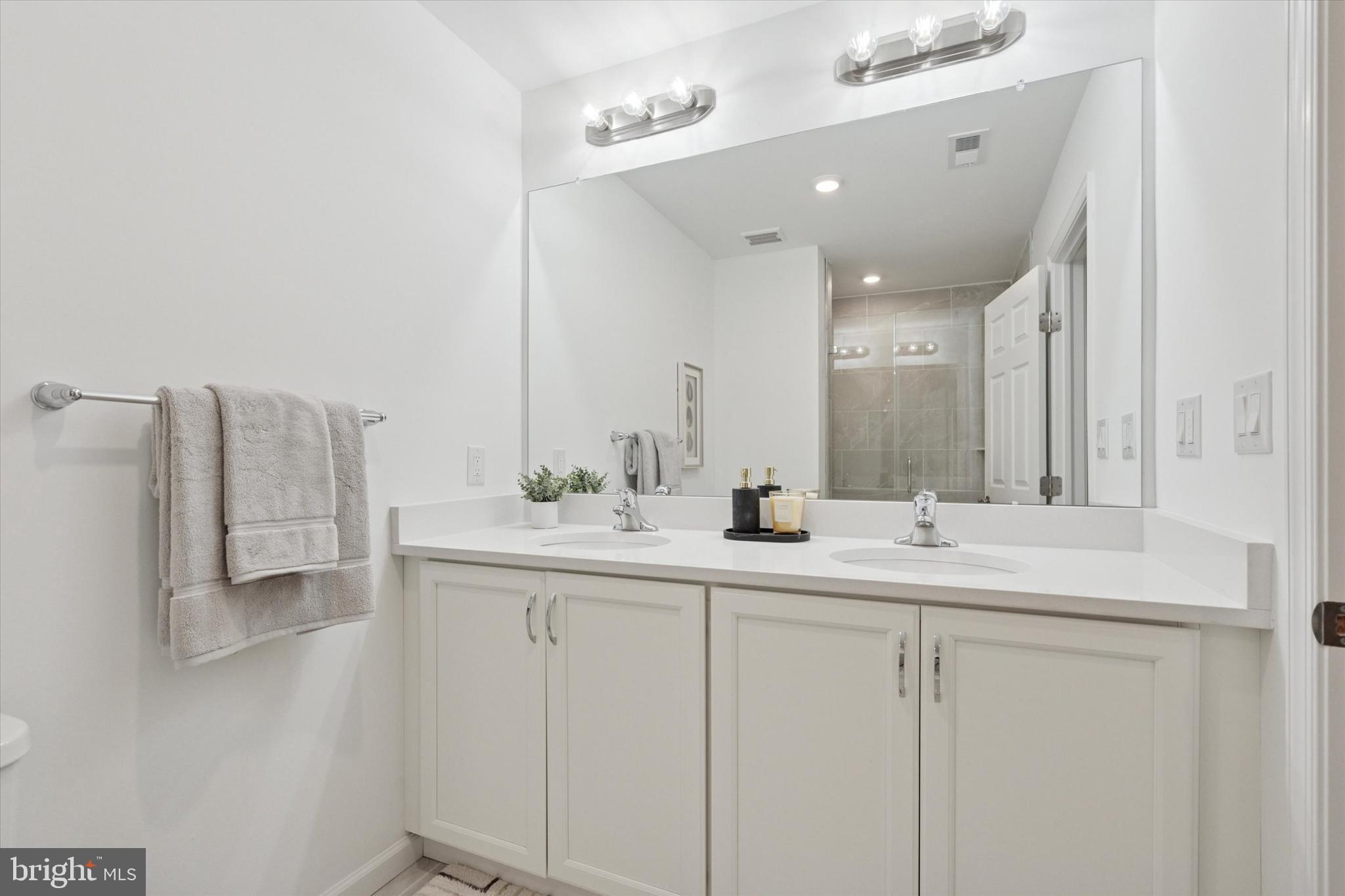 16241 River View Circle Bristol, PA 19007 - Photo 13 of 47 a bathroom with double sink and mirror