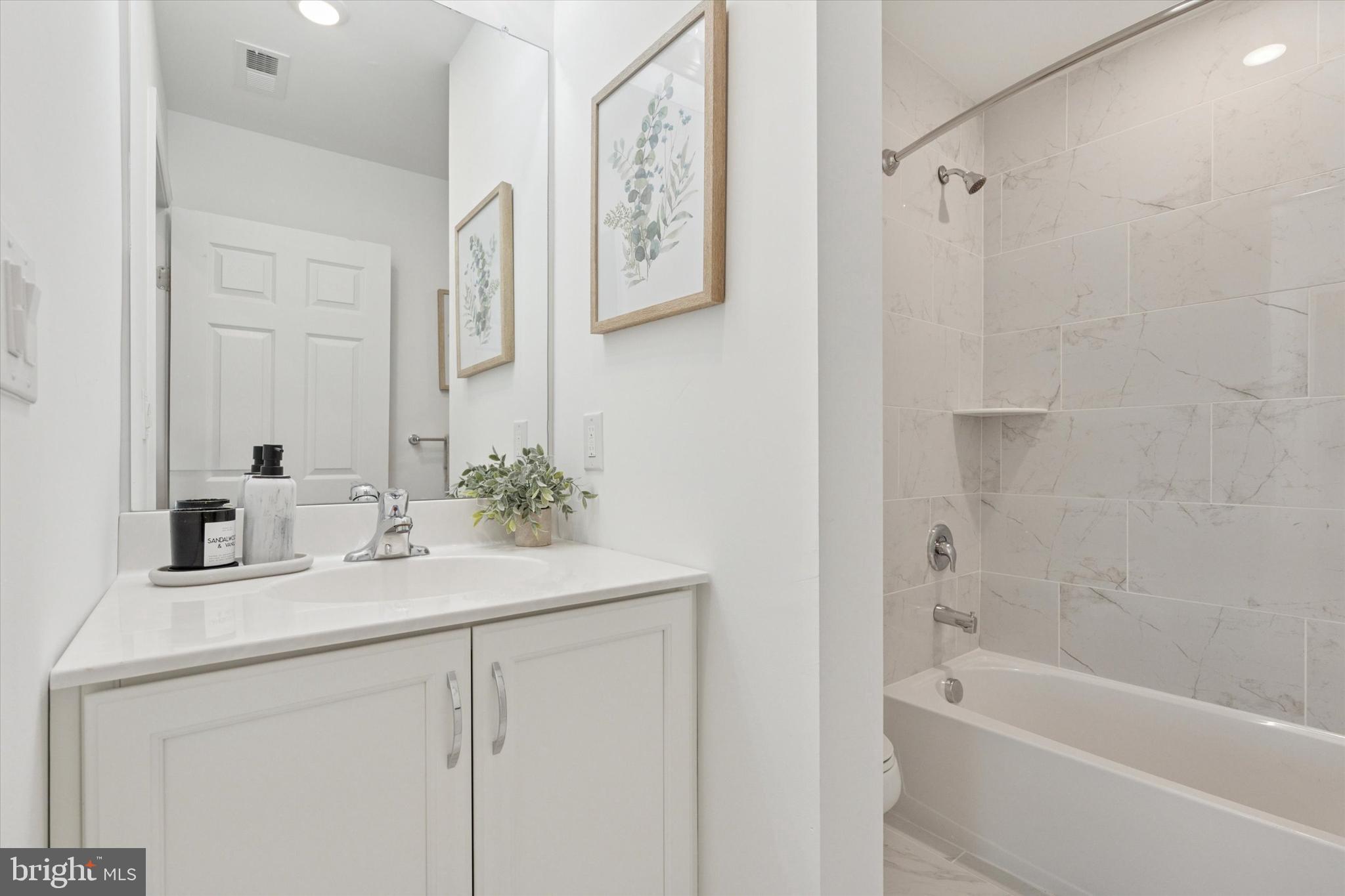 16241 River View Circle Bristol, PA 19007 - Photo 16 of 47 a bathroom with a bathtub sink vanity and mirror