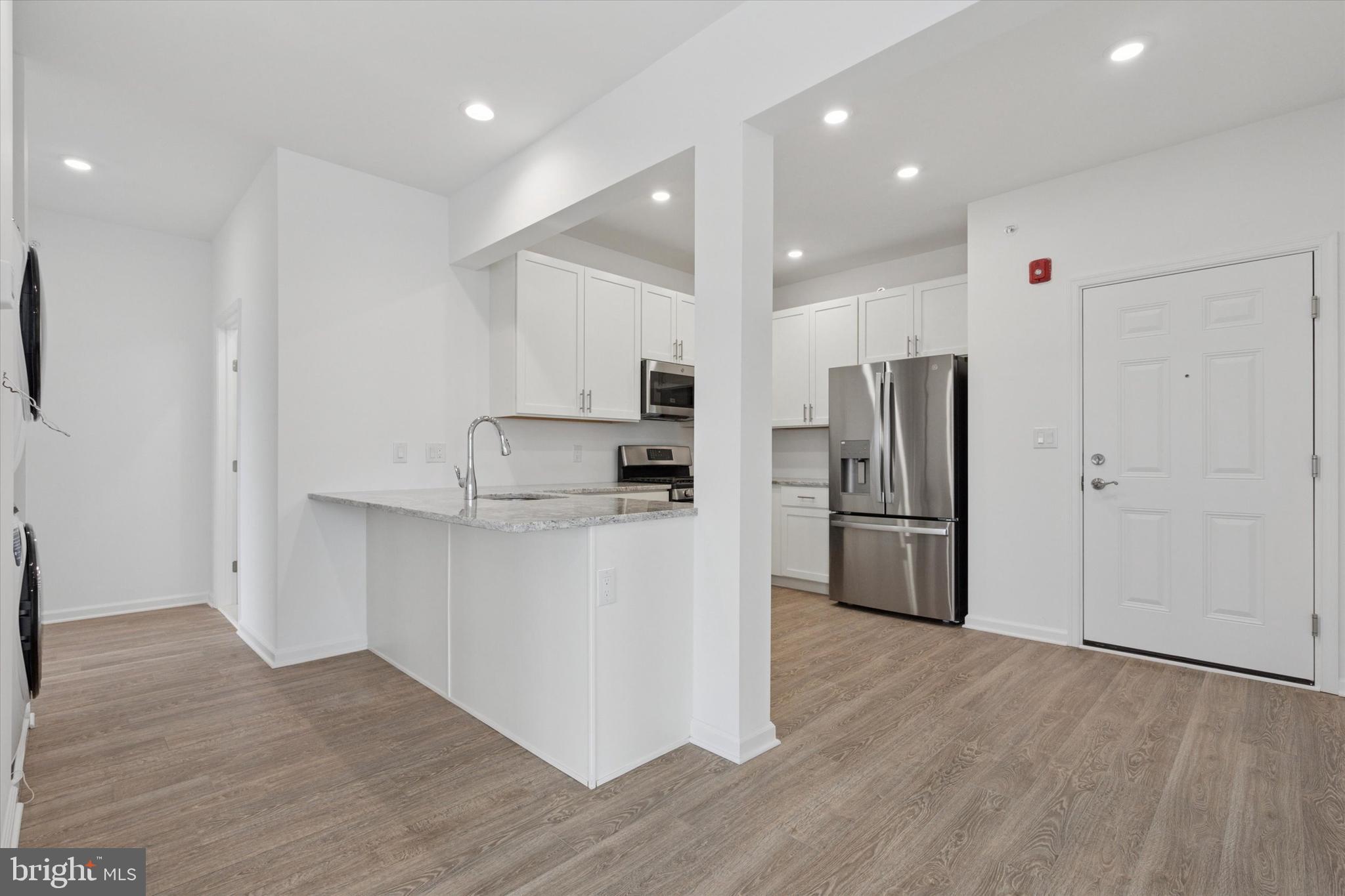 16241 River View Circle Bristol, PA 19007 - Photo 19 of 47 a kitchen with stainless steel appliances a refrigerator and a stove top oven
