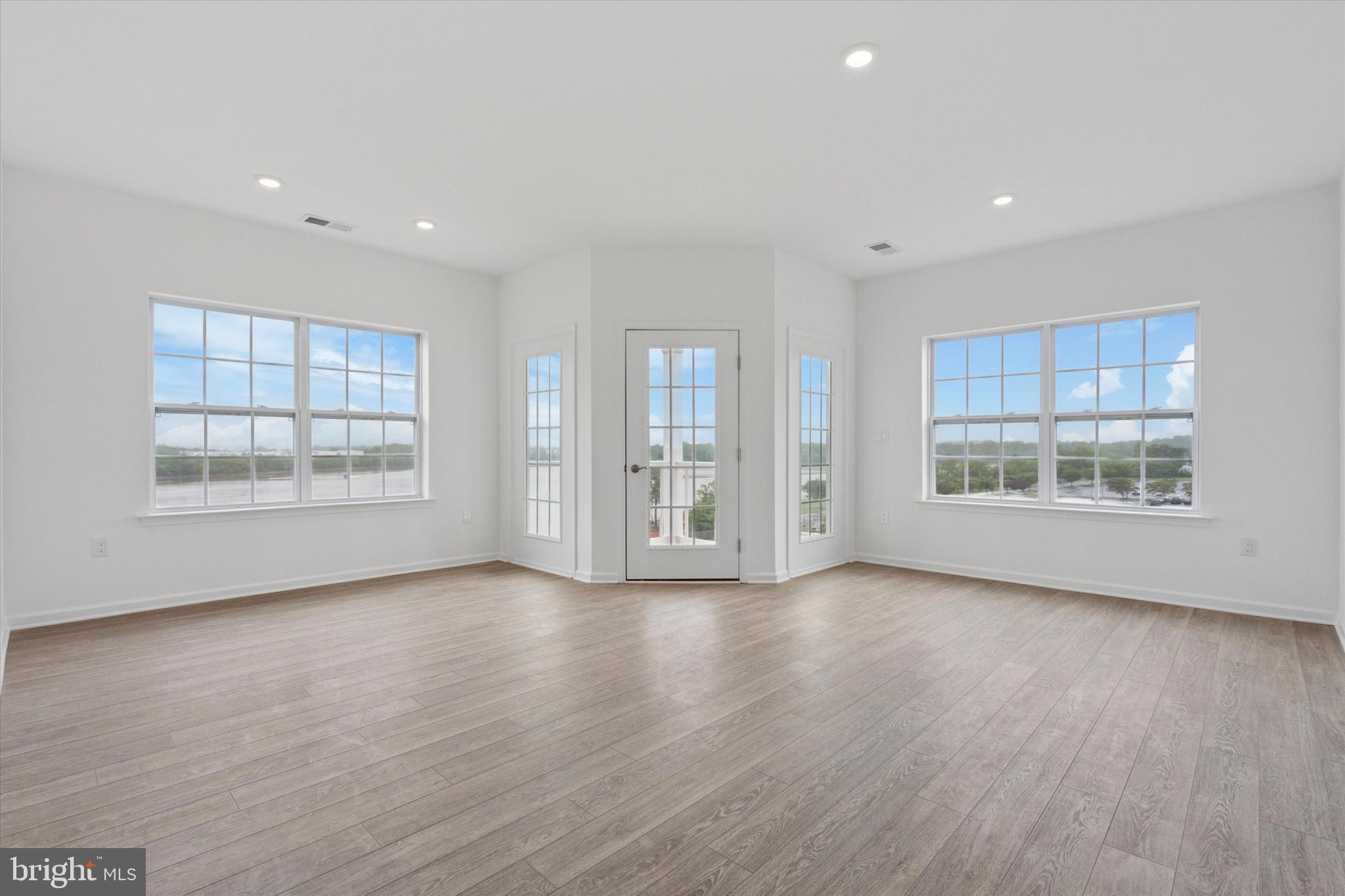 16241 River View Circle Bristol, PA 19007 - Photo 20 of 47 a view of an empty room with a window and wooden floor