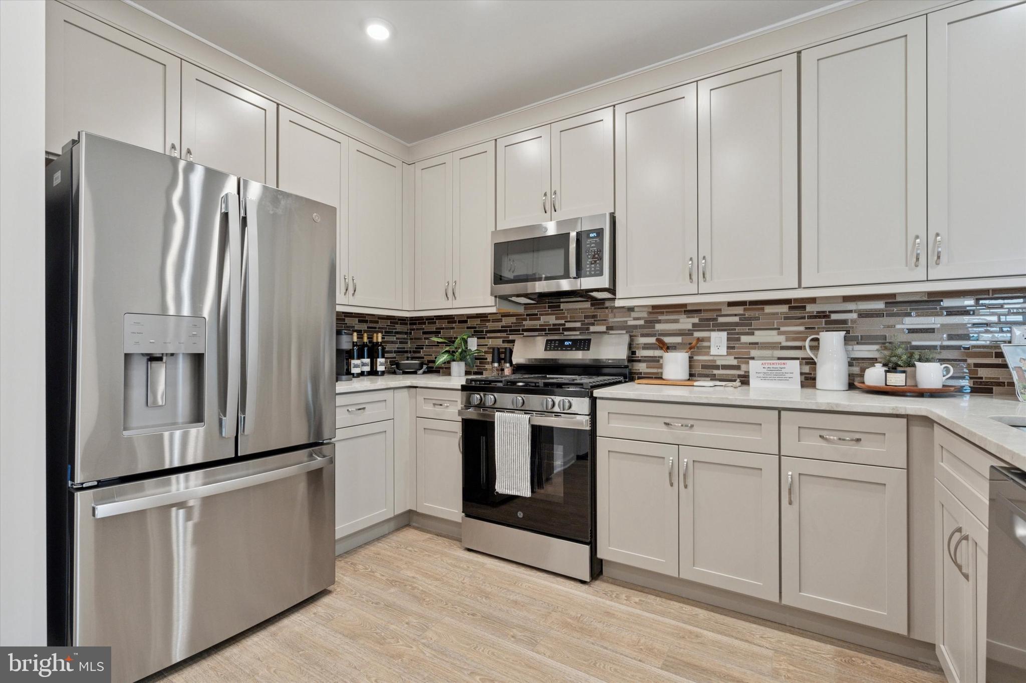 16241 River View Circle Bristol, PA 19007 - Photo 6 of 47 a kitchen with cabinets stainless steel appliances and a counter space