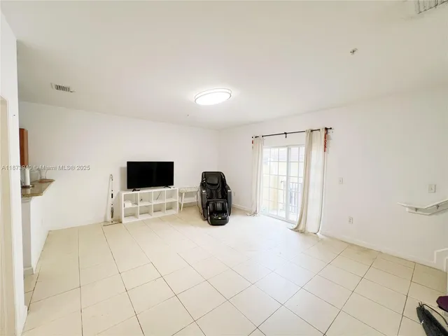 a large bedroom with a bed and tv
