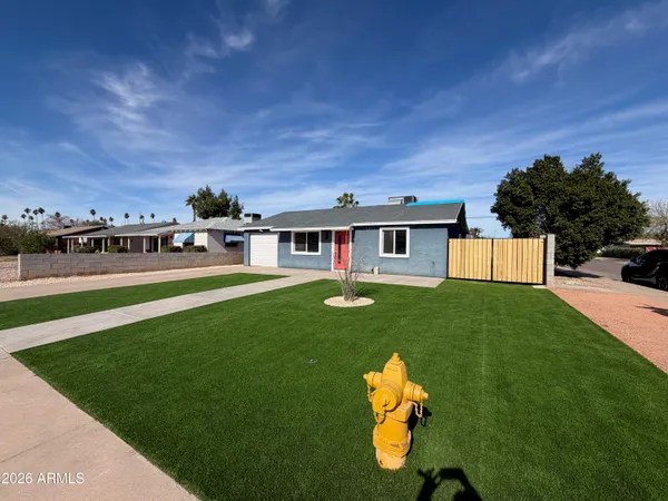 a view of a house with a backyard porch and sitting area