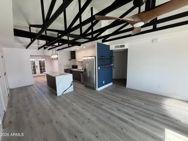 a view of empty room with wooden floor