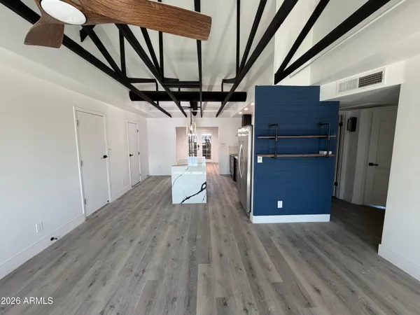 a kitchen with stainless steel appliances a table and chairs in it