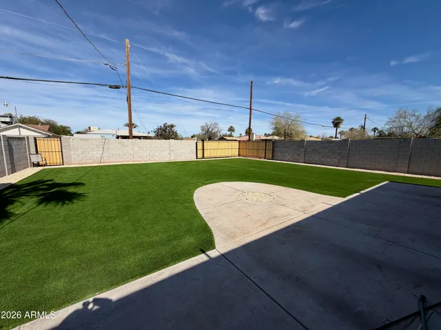 a view of a backyard with table and chairs