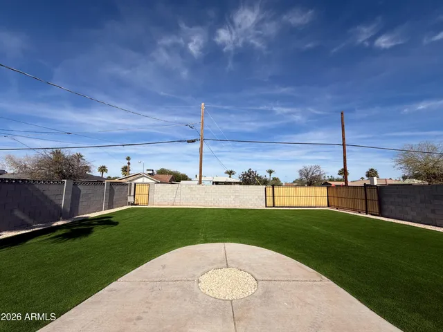 a view of a house with a yard and sitting area
