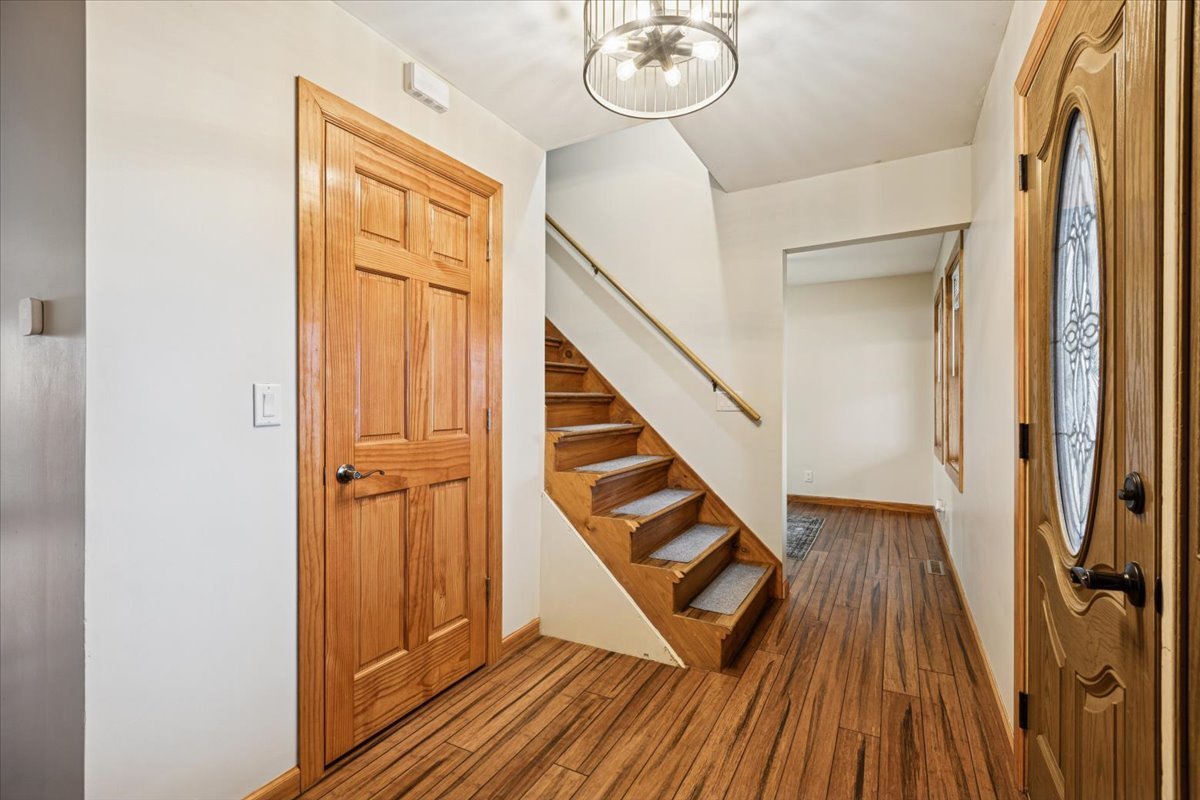 3326 Hayes Road Steward, IL 60553 - Photo 2 of 22 a view of a hallway with wooden floor and staircase