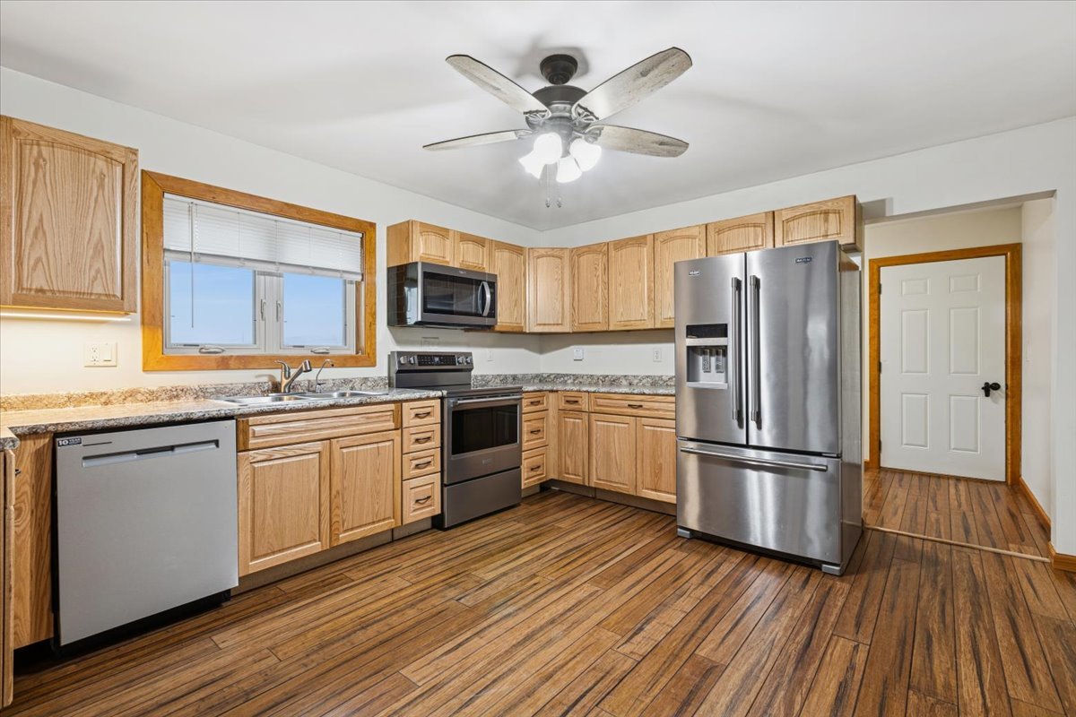 3326 Hayes Road Steward, IL 60553 - Photo 6 of 22 a kitchen with granite countertop stainless steel appliances a refrigerator cabinets and wooden floor