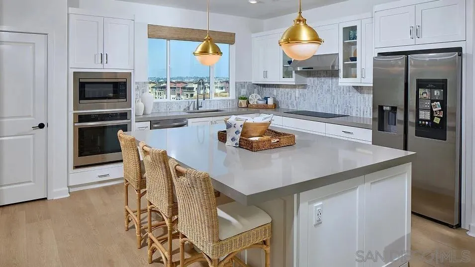 483 Gadget Road San Marcos, CA 92078 - Photo 4 of 20 a kitchen with stainless steel appliances a dining table and chairs