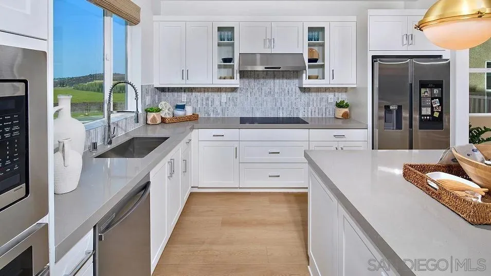 483 Gadget Road San Marcos, CA 92078 - Photo 5 of 20 a kitchen with stainless steel appliances granite countertop a stove a sink and a refrigerator