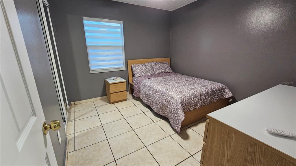 305 Gardenia Road Kissimmee, FL 34743 - Photo 12 of 28 a bedroom with a bed and a window