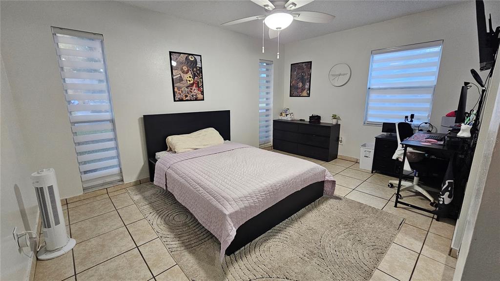 305 Gardenia Road Kissimmee, FL 34743 - Photo 13 of 28 a bedroom with a bed and a desk