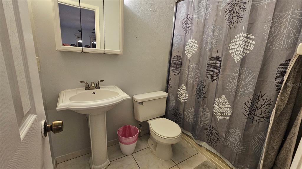 305 Gardenia Road Kissimmee, FL 34743 - Photo 14 of 28 a bathroom with a sink toilet and shower