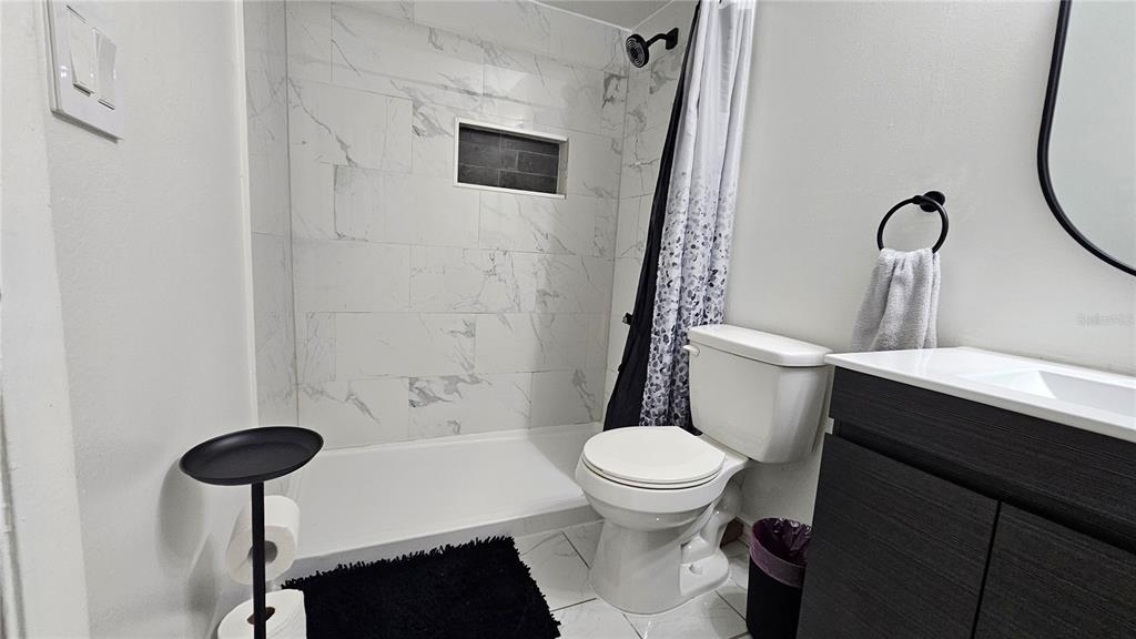 305 Gardenia Road Kissimmee, FL 34743 - Photo 16 of 28 a white toilet sitting next to a bathroom sink