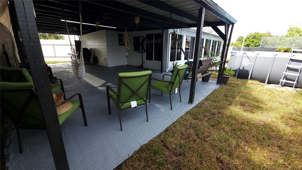 305 Gardenia Road Kissimmee, FL 34743 - Photo 18 of 28 a view of a porch with furniture and a yard