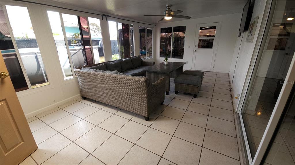 305 Gardenia Road Kissimmee, FL 34743 - Photo 22 of 28 a living room with furniture and a floor to ceiling window