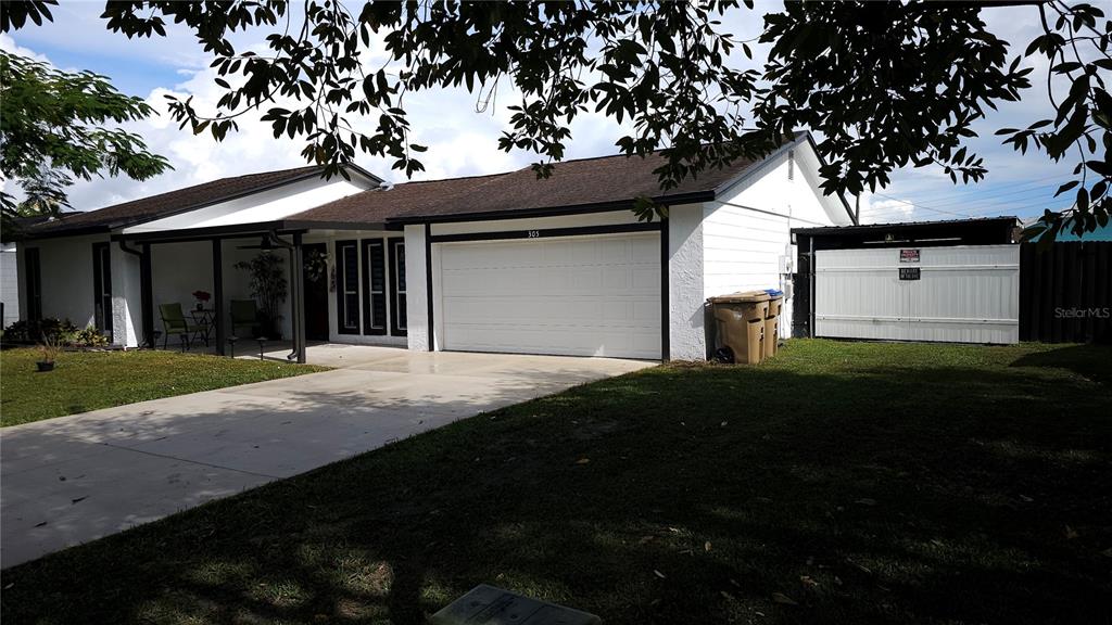 305 Gardenia Road Kissimmee, FL 34743 - Photo 3 of 28 a house view with a garden space
