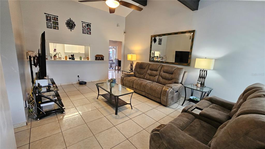 305 Gardenia Road Kissimmee, FL 34743 - Photo 4 of 28 a living room with furniture and a flat screen tv