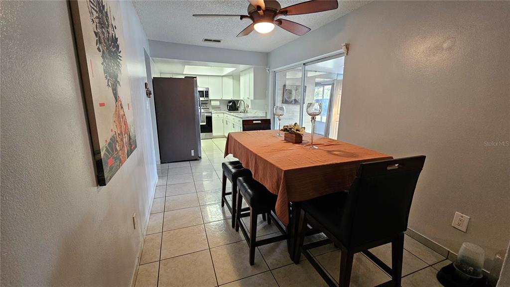 305 Gardenia Road Kissimmee, FL 34743 - Photo 6 of 28 a open kitchen with stainless steel appliances granite countertop a refrigerator and a sink