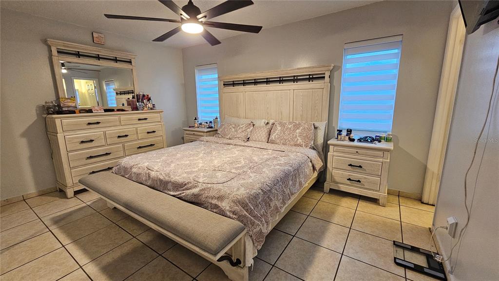 305 Gardenia Road Kissimmee, FL 34743 - Photo 10 of 28 a bedroom with a bed and a mirror on the dresser