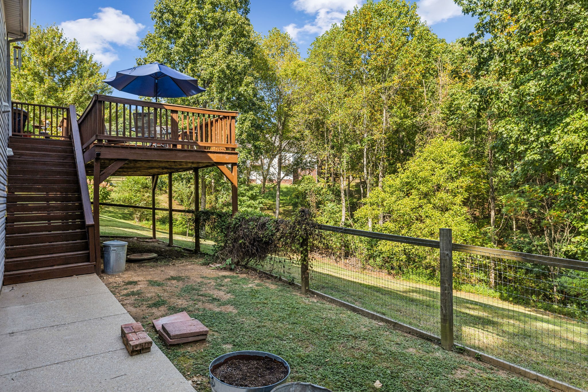 7608 Aubrey Ridge Court Fairview, TN 37062 - Photo 22 of 32 a view of a backyard with a small deck and a garden