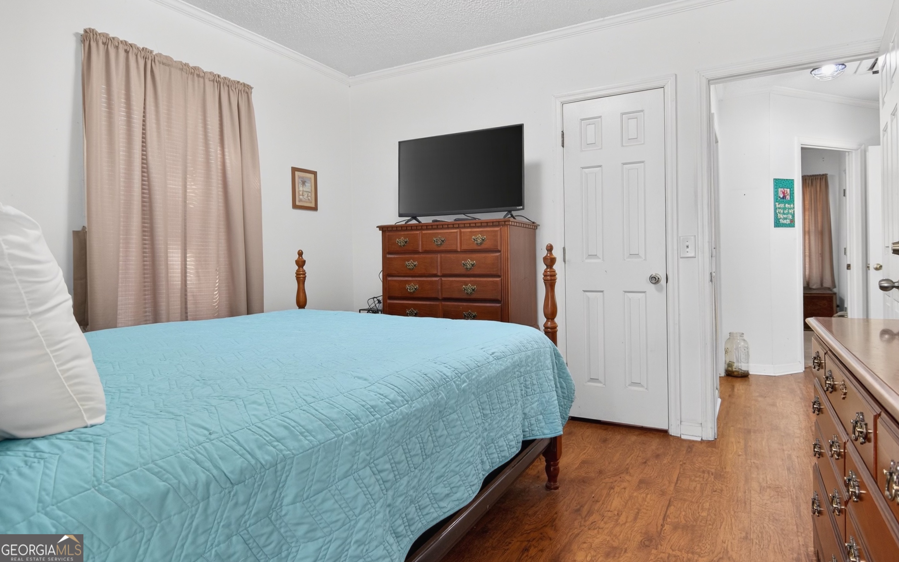 127 West Stuart Avenue Lyons, GA 30436 - Photo 18 of 71 a bedroom with a bed and wooden floor