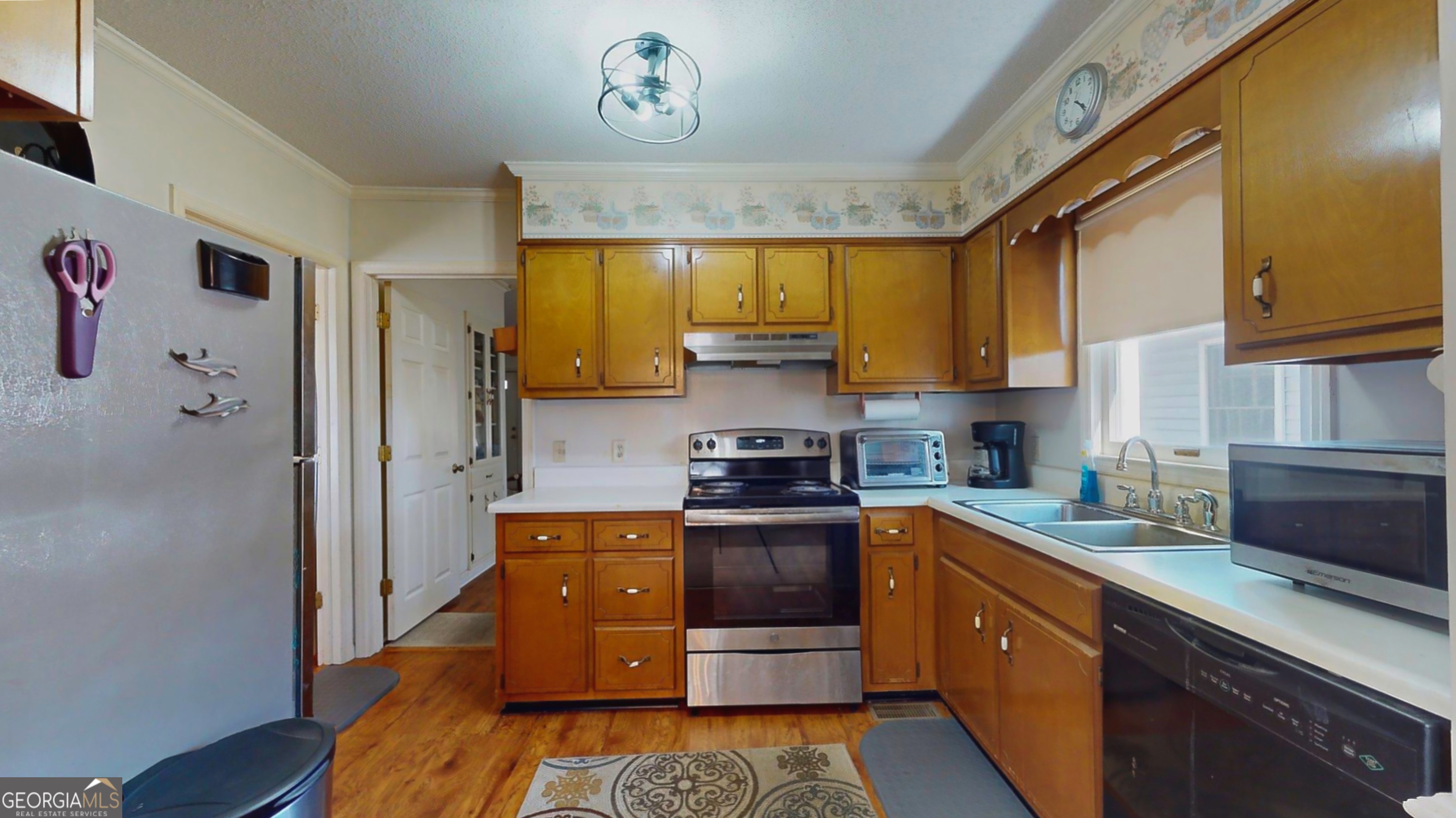 127 West Stuart Avenue Lyons, GA 30436 - Photo 59 of 71 a kitchen with stainless steel appliances granite countertop a refrigerator a sink dishwasher a stove with wooden floor and cabinets