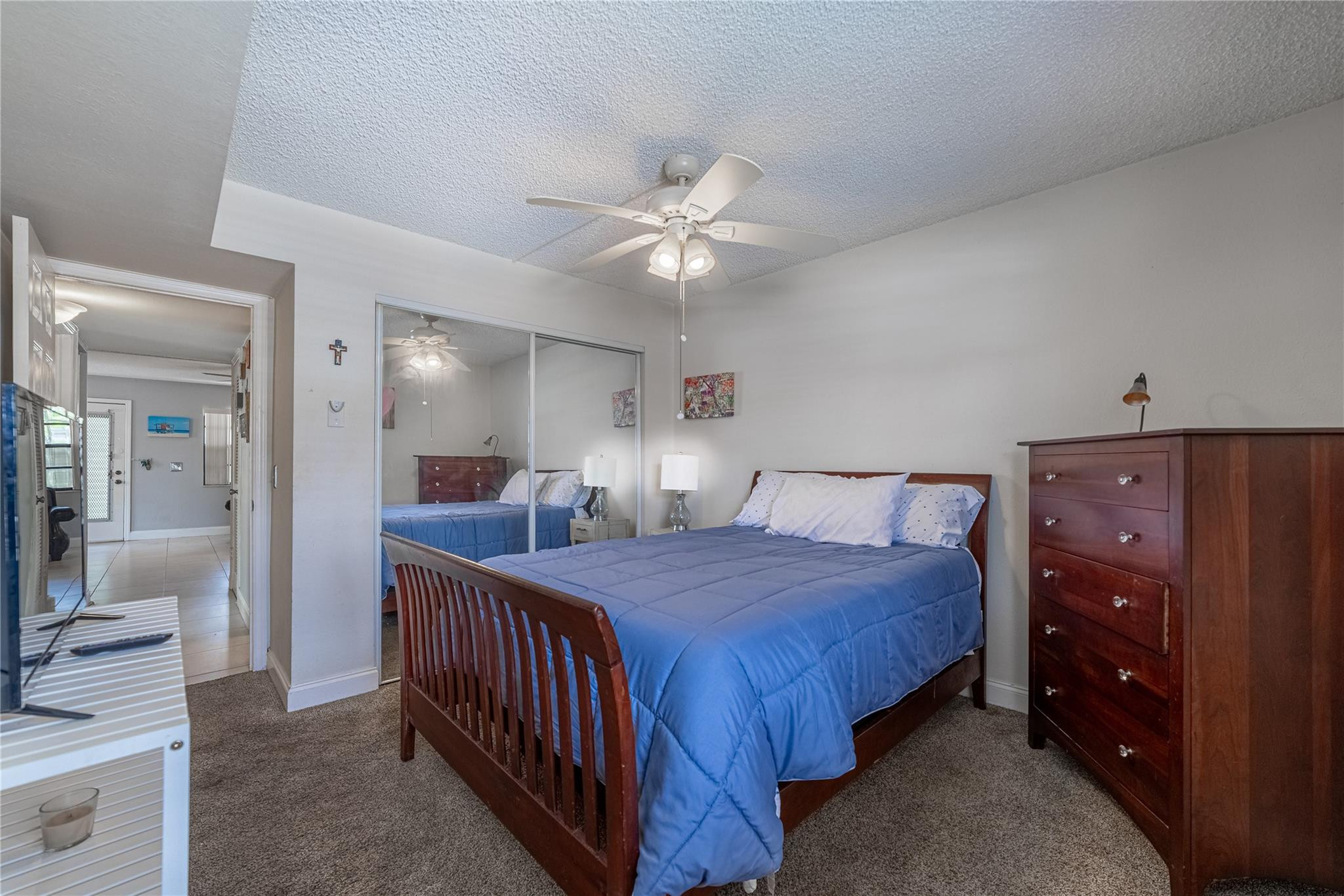 103 Capri B, Unit 103 Delray Beach, FL 33484 - Photo 14 of 24 a bedroom with a bed and a chandelier
