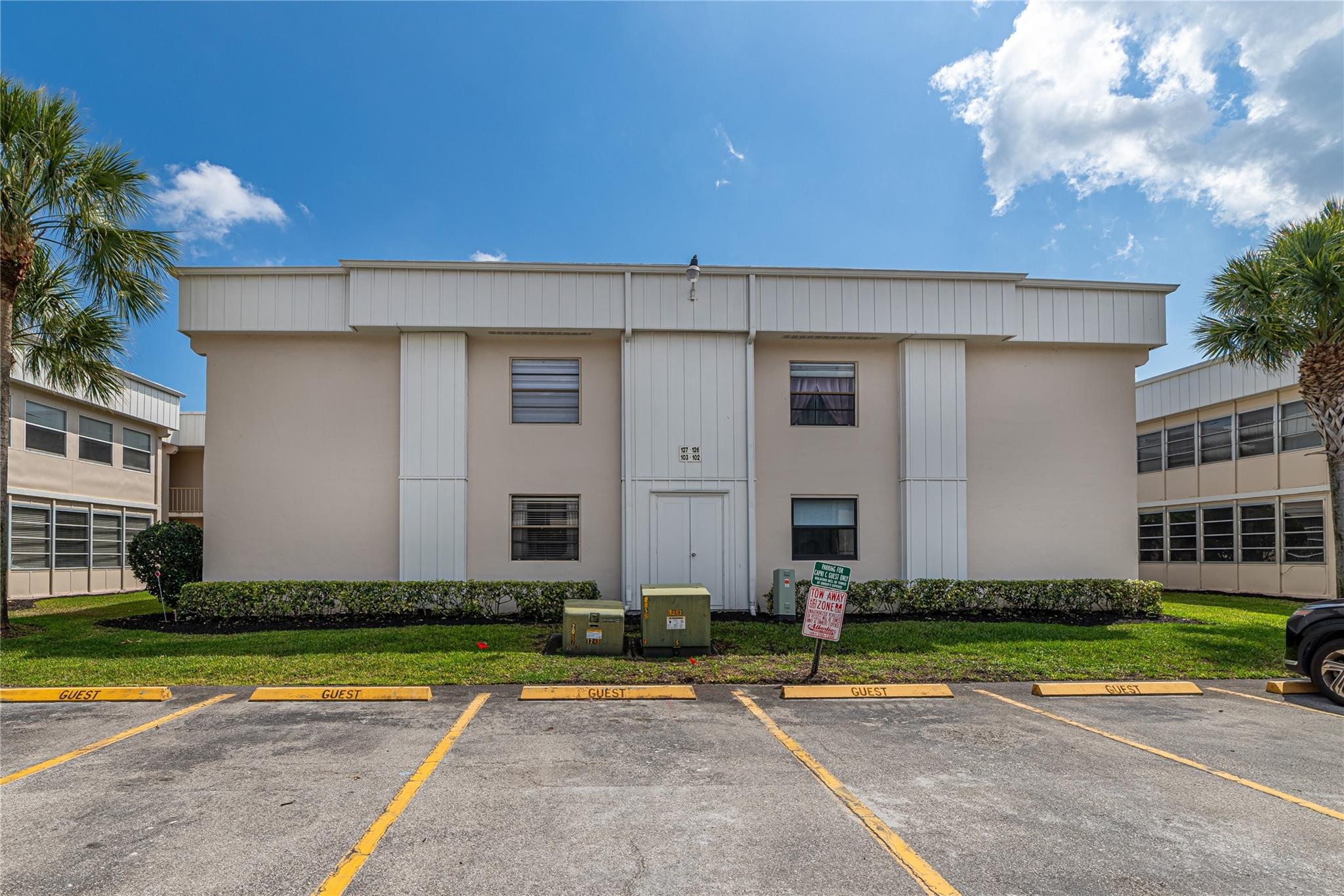 103 Capri B, Unit 103 Delray Beach, FL 33484 - Photo 15 of 24 a front view of a house with a yard