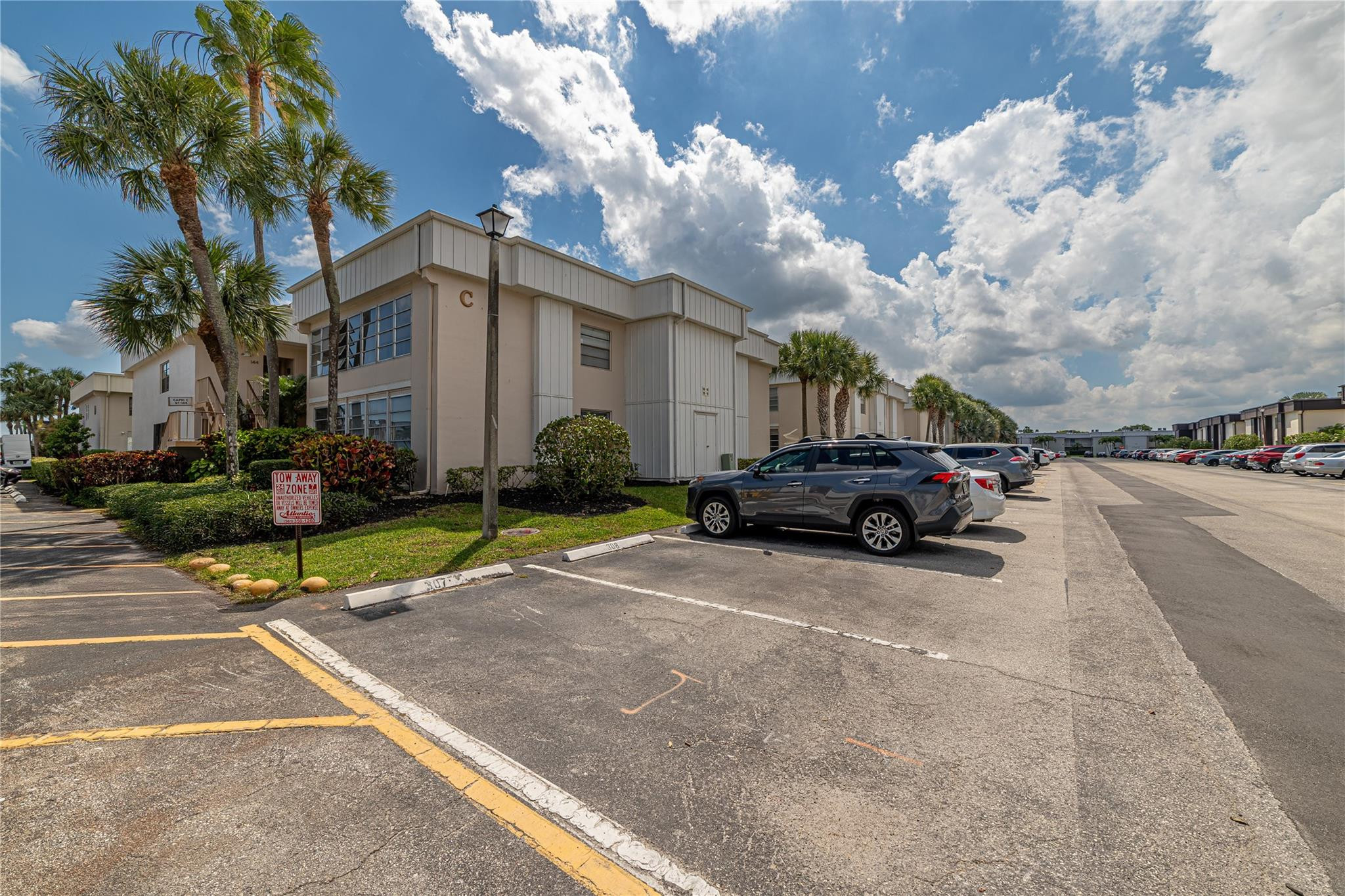 103 Capri B, Unit 103 Delray Beach, FL 33484 - Photo 17 of 24 a view of a car parked in front of a building
